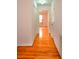 Long hallway with pristine hardwood floors and white trim at 2300 Bethera Rd # A, Bonneau, SC 29431