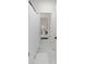 Well-lit bathroom area featuring white-tile flooring and a shower with a curtain at 2372 Darts Cove Way, Mount Pleasant, SC 29466