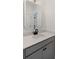 Modern half-bath with vanity, gray cabinets, white countertop, black faucet, and decorative mirror at 2372 Darts Cove Way, Mount Pleasant, SC 29466