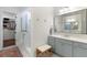Well-lit bathroom with double vanity, modern fixtures, tiled shower and a view into the walk-in closet at 2372 Darts Cove Way, Mount Pleasant, SC 29466