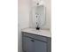 Nicely appointed half bath featuring gray cabinets, modern fixtures, and decorative mirror at 2372 Darts Cove Way, Mount Pleasant, SC 29466