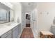 Stylish bathroom with double vanity, neutral paint, walk-in shower and a view into the walk-in closet at 2372 Darts Cove Way, Mount Pleasant, SC 29466