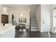 Light-filled dining area featuring hardwood floors, bench seating, a modern chandelier and access to outdoor space at 2372 Darts Cove Way, Mount Pleasant, SC 29466