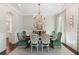 Beautiful dining room with a wooden table, decorative chairs, and a view into the modern kitchen at 2372 Darts Cove Way, Mount Pleasant, SC 29466