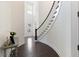 Grand foyer featuring a curved staircase, dark hardwood floors, and ample natural light at 2372 Darts Cove Way, Mount Pleasant, SC 29466