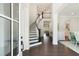 Elegant foyer with a curved staircase, hardwood floors, and a chandelier, creating a grand entrance at 2372 Darts Cove Way, Mount Pleasant, SC 29466