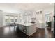 Spacious white kitchen featuring a large island with seating, modern lighting, and stainless steel appliances at 2372 Darts Cove Way, Mount Pleasant, SC 29466