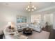 Comfortable living room with elegant decor, featuring a large sectional sofa and access to the kitchen at 2372 Darts Cove Way, Mount Pleasant, SC 29466