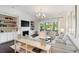 Bright living room with fireplace, built-in shelving, modern lighting, and comfortable seating near a balcony at 2372 Darts Cove Way, Mount Pleasant, SC 29466
