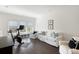 Bright bonus room featuring hardwood floors, comfortable seating, and a Peloton exercise bike at 2372 Darts Cove Way, Mount Pleasant, SC 29466