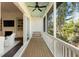 Relaxing screened-in porch with wooden floors, white railings, a swing and views of lush greenery at 2372 Darts Cove Way, Mount Pleasant, SC 29466