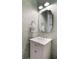 Charming powder room with designer wallpaper, marble countertop vanity, decorative mirror and towel ring at 2372 Darts Cove Way, Mount Pleasant, SC 29466