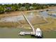 Aerial view of a private pier and dock with a boat, surrounded by marsh and waterfront homes at 2372 Darts Cove Way, Mount Pleasant, SC 29466