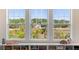 Three large windows offer scenic views of lush greenery and natural surroundings at 2372 Darts Cove Way, Mount Pleasant, SC 29466