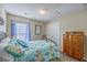Charming bedroom with light blue coastal themed quilt, ceiling fan, and neutral paint at 2427 Stingray Blvd, North Charleston, SC 29406