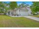 Charming single-story home with a well-manicured lawn, attached garage, and beautiful landscaping at 2427 Stingray Blvd, North Charleston, SC 29406