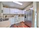 Well-lit kitchen featuring white cabinets, stainless steel refrigerator, and hardwood flooring at 2427 Stingray Blvd, North Charleston, SC 29406