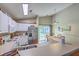 Eat-in kitchen offers white cabinets, stainless steel appliances, and access to the backyard patio at 2427 Stingray Blvd, North Charleston, SC 29406