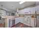 Bright kitchen features stainless steel dishwasher, white appliances, and open concept design at 2427 Stingray Blvd, North Charleston, SC 29406