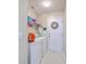 Functional laundry room with washer, dryer, shelving, and exterior door at 2427 Stingray Blvd, North Charleston, SC 29406