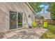 Back patio with green chairs and sliding glass doors to enter into the residence at 2427 Stingray Blvd, North Charleston, SC 29406