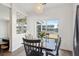Bright dining area features dark wood table set with hardwood floors and backyard lake views at 247 Godwit Dr, Summerville, SC 29486