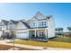 Charming two-story home with well-manicured lawn, a small porch, and pond access at 247 Godwit Dr, Summerville, SC 29486