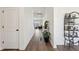Hallway features hardwood floors, white walls, and decoratively placed plants at 247 Godwit Dr, Summerville, SC 29486