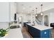 Modern kitchen boasts a large island, stainless appliances, white cabinets, and pendant lighting at 247 Godwit Dr, Summerville, SC 29486