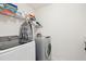 Functional laundry room with modern washer and dryer, and shelving for storage at 247 Godwit Dr, Summerville, SC 29486