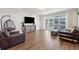 Stylish living room with modern furniture, hardwood floors, and access to a screened-in patio at 247 Godwit Dr, Summerville, SC 29486