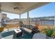Screened patio with ceiling fan, fire pit, comfortable couch and view of the lake at 247 Godwit Dr, Summerville, SC 29486