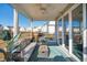 Covered porch with a cozy couch, fire pit and lake view in the backyard at 247 Godwit Dr, Summerville, SC 29486