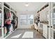 Walk-in closet features full-length shelving and natural light from backyard windows at 247 Godwit Dr, Summerville, SC 29486
