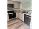 Newly updated kitchen features granite countertops, stainless appliances, and stylish wood-look flooring at 2602 Hidden Gove Dr # 2602, Moncks Corner, SC 29461