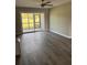 Comfortable living room with ceiling fan and access to the screened in porch with views of green space at 2602 Hidden Gove Dr # 2602, Moncks Corner, SC 29461