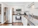 Well-lit kitchen with stainless steel appliances, granite countertops, and white cabinetry at 27 Brockman Dr # 27-C, Charleston, SC 29412