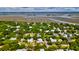 An aerial view of a neighborhood featuring beautiful homes, lush greenery, and a serene coastal landscape in the background at 2870 Ion Ave, Sullivans Island, SC 29482