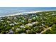 Picturesque aerial of coastal homes near the ocean, showcasing a sandy beach and lush green landscape at 2870 Ion Ave, Sullivans Island, SC 29482