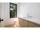 Bright bathroom featuring a tan vanity cabinet, toilet, and window view at 2870 Ion Ave, Sullivans Island, SC 29482