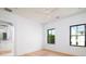 Bright bedroom with hardwood floors, ceiling fan, recessed lighting, and two large windows at 2870 Ion Ave, Sullivans Island, SC 29482