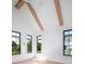 Bright bedroom features wooden beams on the ceiling and three windows with views of the outdoor scenery at 2870 Ion Ave, Sullivans Island, SC 29482