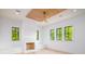 Comfortable bedroom featuring a stylish ceiling fan, three windows, and a decorative fireplace at 2870 Ion Ave, Sullivans Island, SC 29482