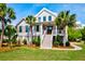 Charming two-story home with a prominent front-facing staircase and meticulously maintained landscaping at 2870 Ion Ave, Sullivans Island, SC 29482