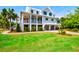 Beautiful two-story home with a lush green lawn and a well-manicured landscape at 2870 Ion Ave, Sullivans Island, SC 29482