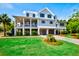 Beautiful two-story home with a lush green lawn and a well-manicured landscape at 2870 Ion Ave, Sullivans Island, SC 29482