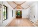 Bright foyer featuring hardwood floors, a decorative ceiling, and a dark-framed window at 2870 Ion Ave, Sullivans Island, SC 29482