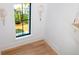 Hallway landing featuring hardwood floors and a view to the backyard from a black-framed window at 2870 Ion Ave, Sullivans Island, SC 29482