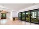 Spacious living room featuring light hardwood floors, a wet bar, and large sliding doors at 2870 Ion Ave, Sullivans Island, SC 29482