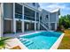 Stunning backyard with a sparkling pool, ample patio space, and beautifully landscaped surroundings at 2870 Ion Ave, Sullivans Island, SC 29482